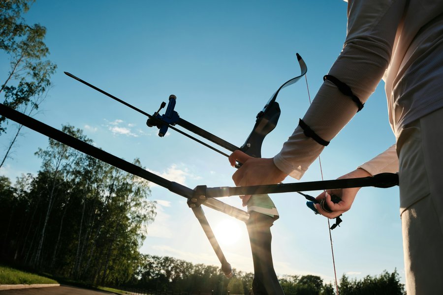 Olympic recurve archer against an open sky