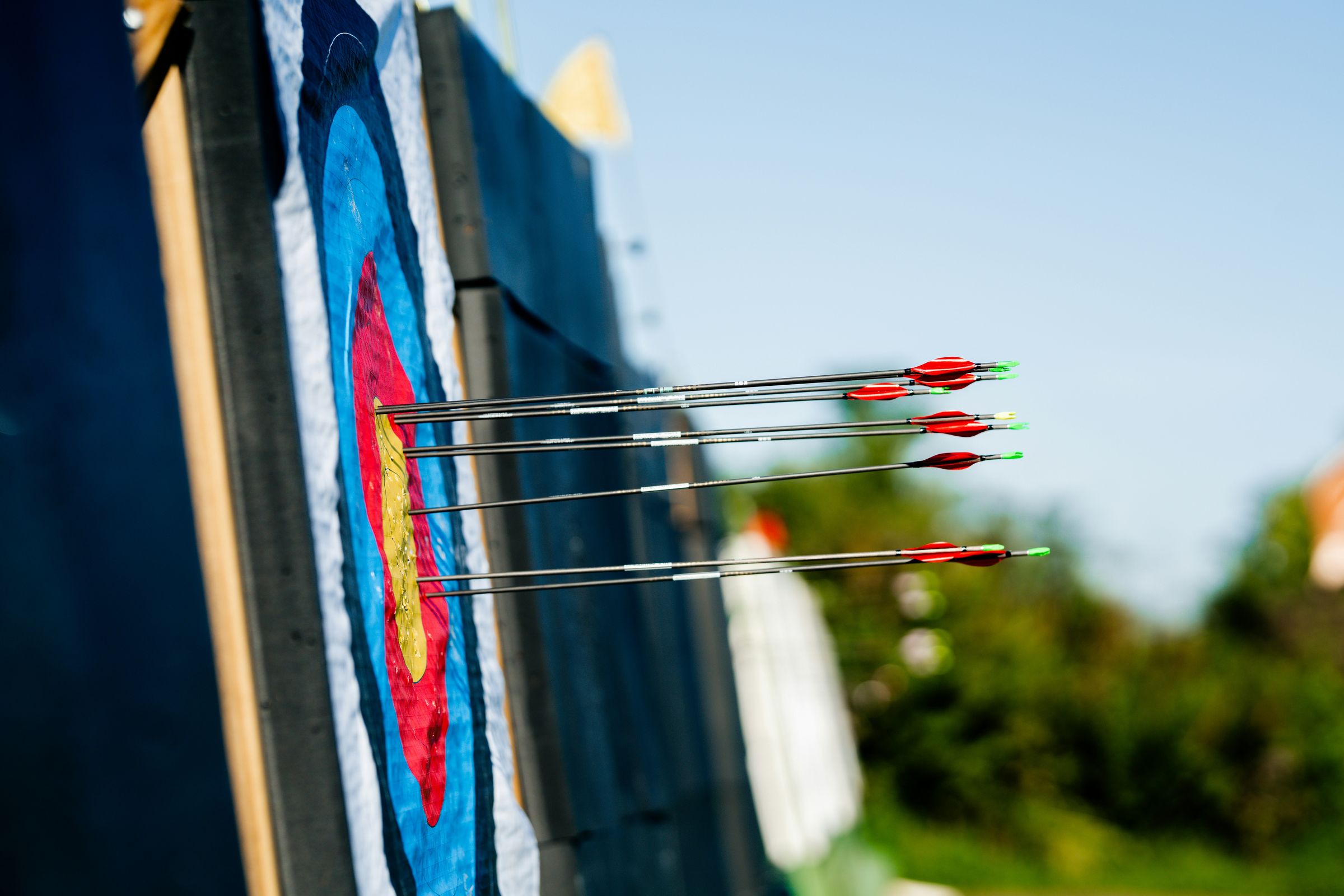 Custom arrows grouped tight in a bullseye — the result of a matched build