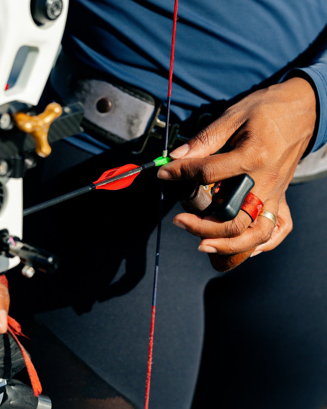 Close detail of arrow nock and red fletching on a competition setup