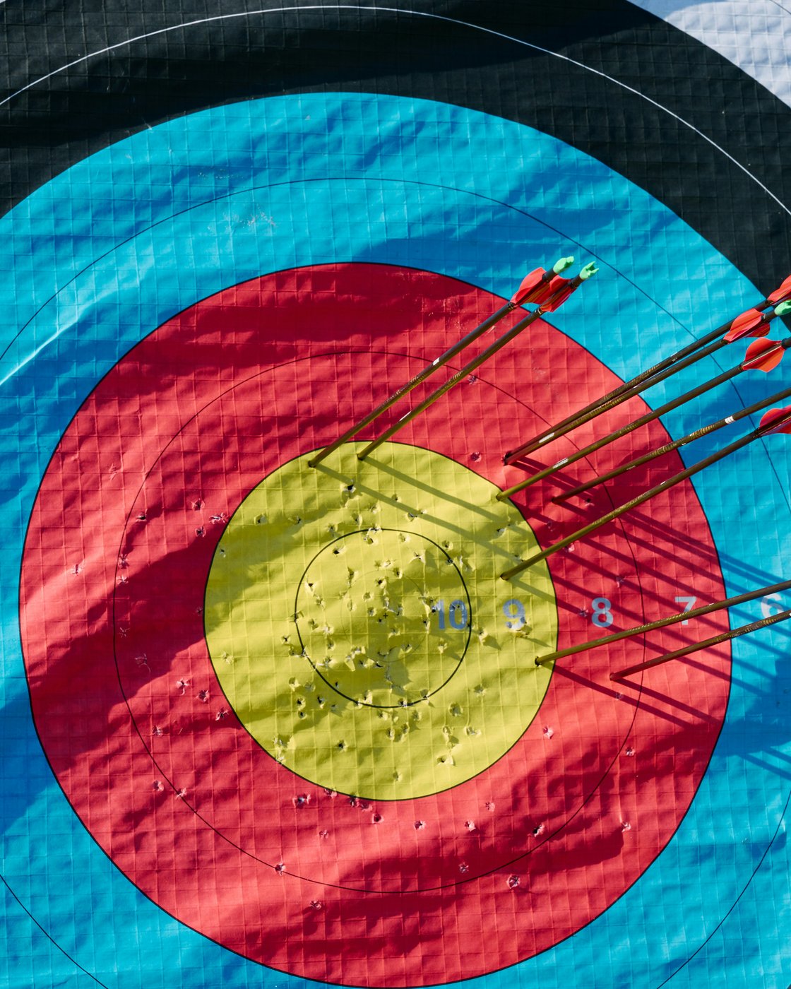 Tight arrow group on a competition target — consistent form on display